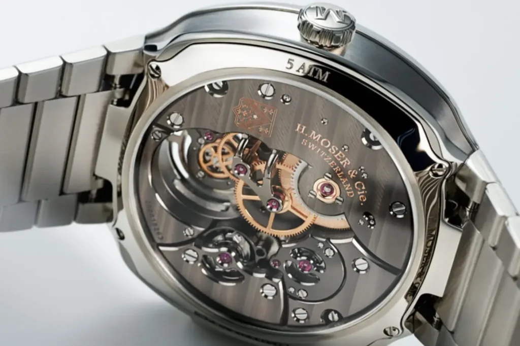 La H. Moser - Montre argent ou acier? Comparatif Rolex, Omega 2026 + prix réels